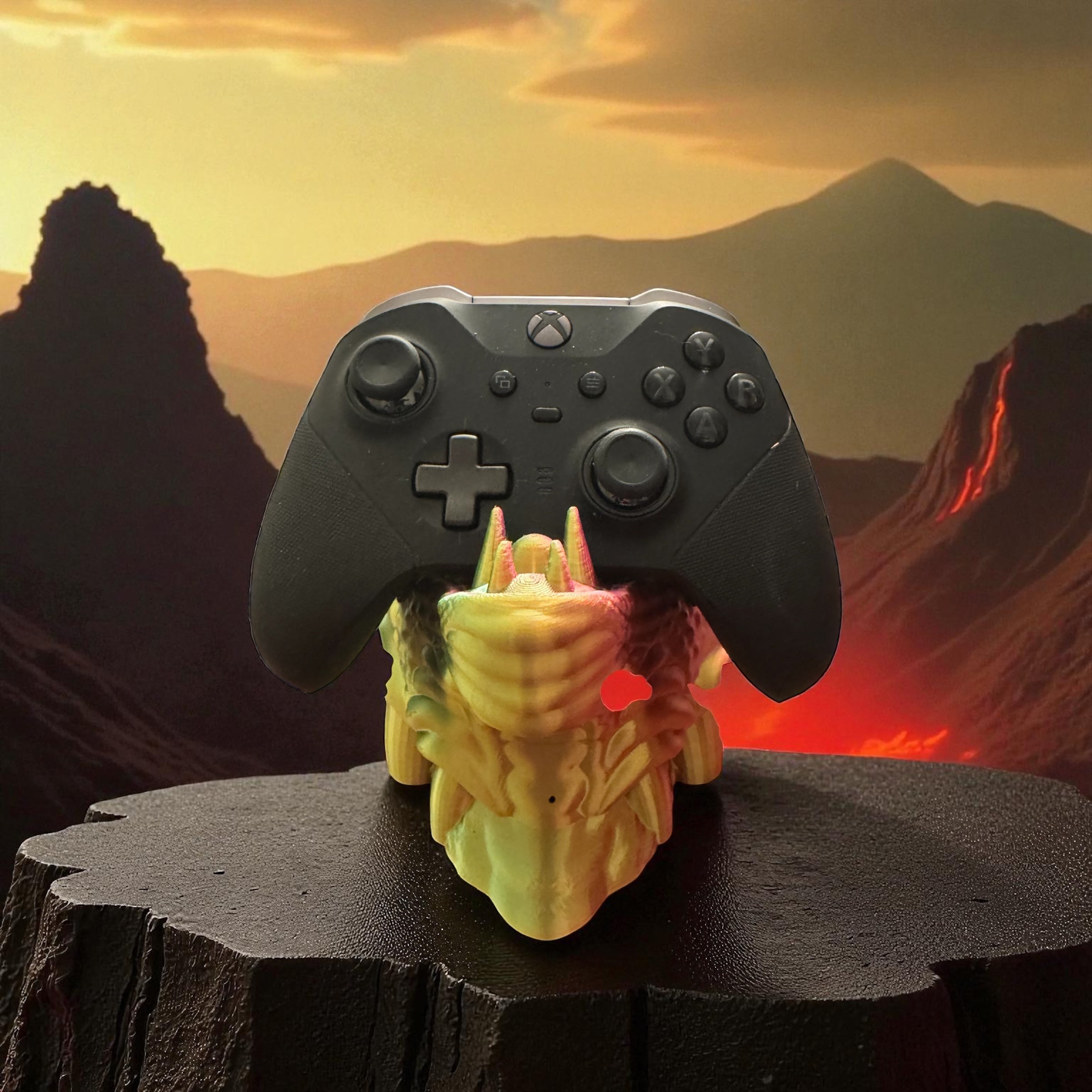 Black gaming controller on a dragon controller holder with a mountainous landscape in the background