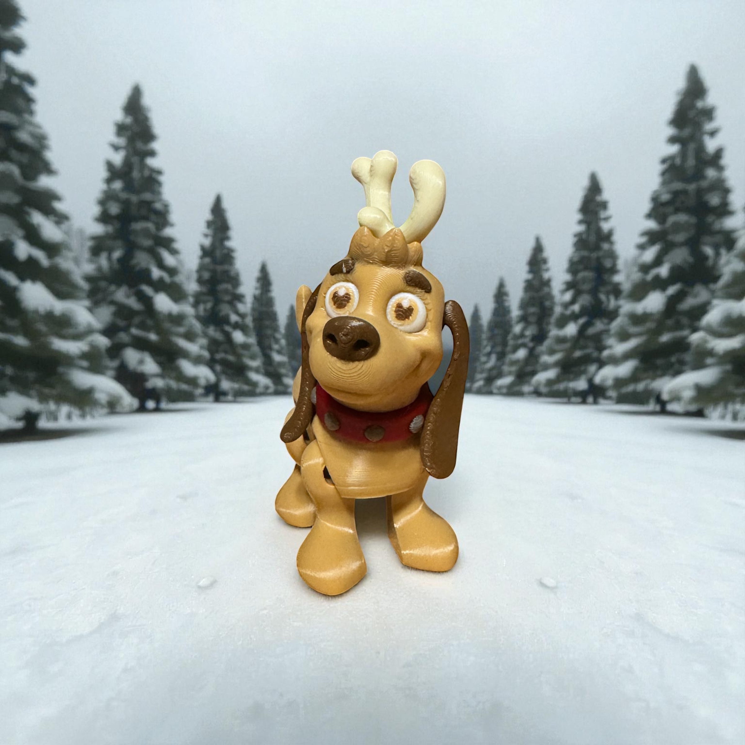 Max the dog figure with antlers in a snowy landscape with trees