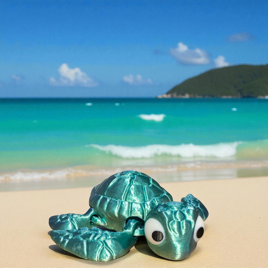 Turquoise turtle figurine on a sandy beach with ocean and sky in the background