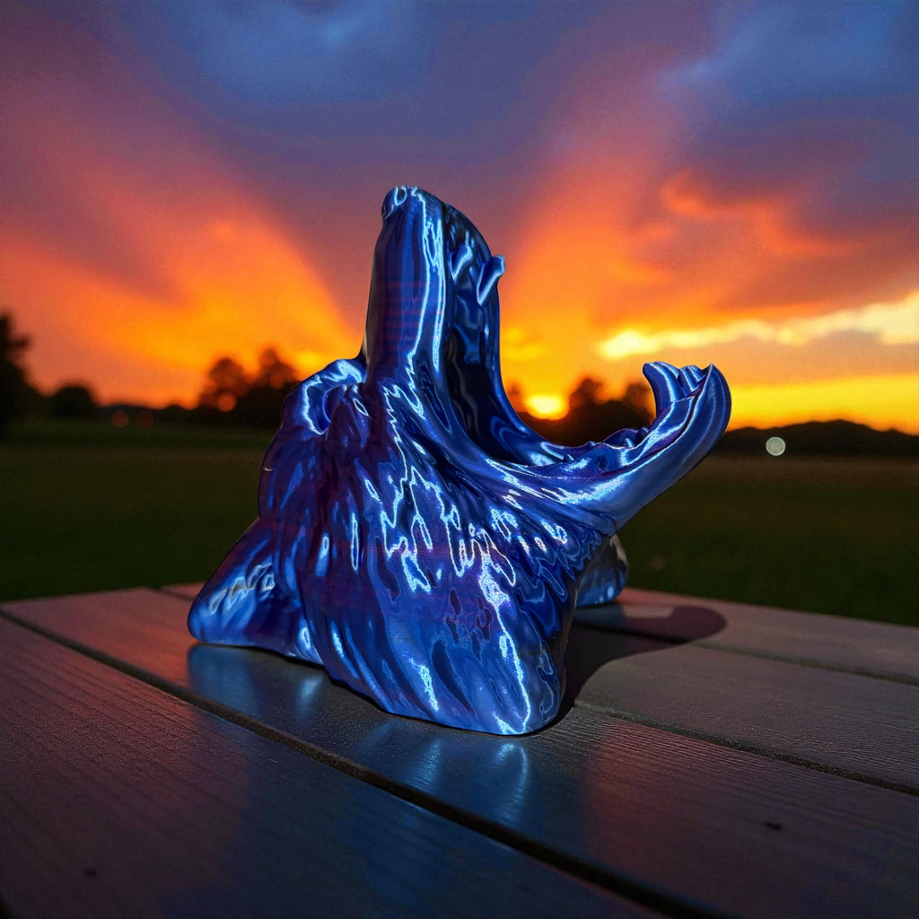 Blue Wolf Controller holder on a wooden surface with a sunset sky in the background